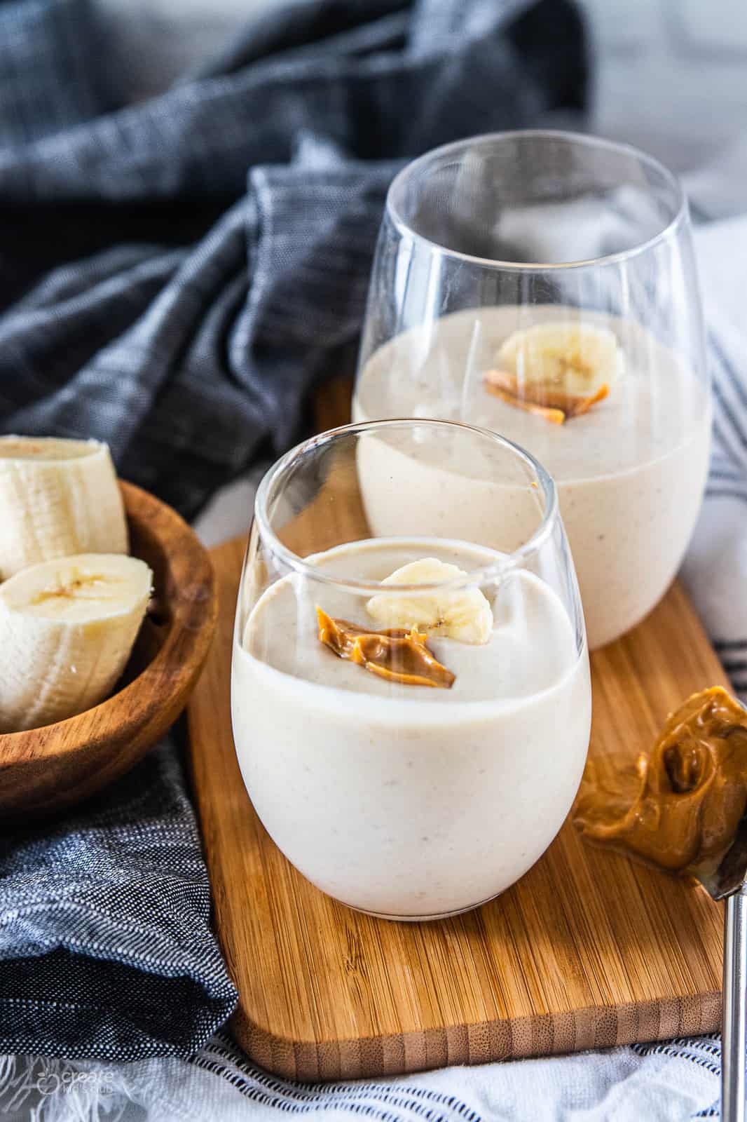 peanut butter banana smoothie in drinking glasses