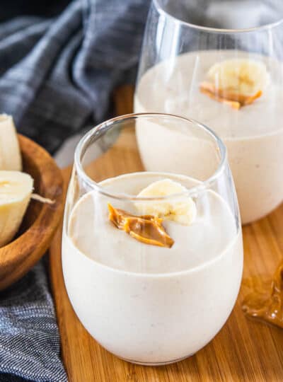 peanut butter banana smoothie in drinking glasses