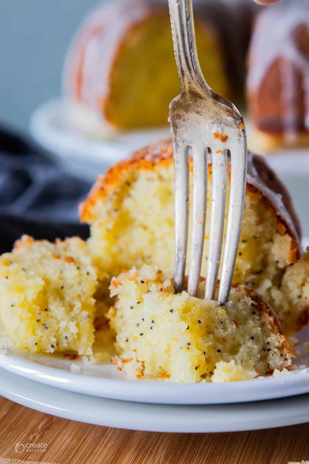 slice of lemon poppyseed cake on plate with fork