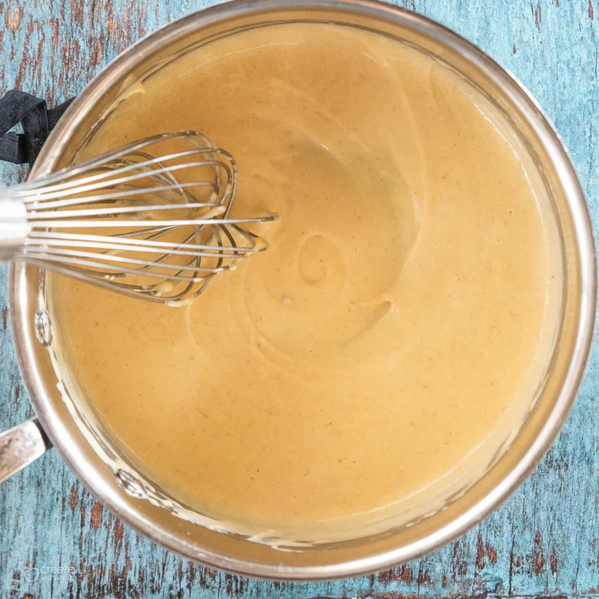 cheese sauce in a mixing bowl 