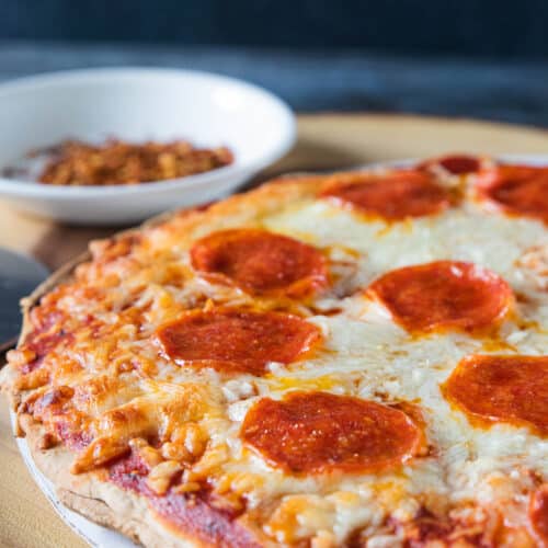Par baked pepperoni pizza shown after baking, before being sliced.
