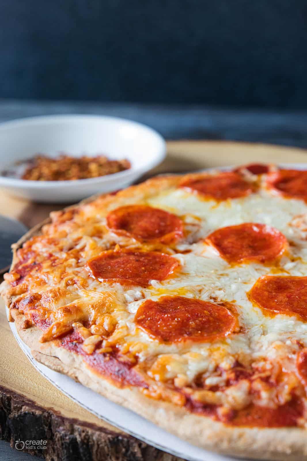 Par baked pepperoni pizza shown after baking, before being sliced.