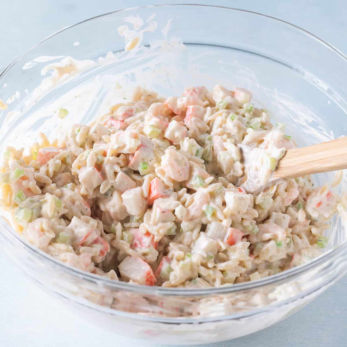 cold summer salad mixed together in bowl