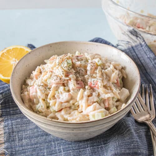 Seafood salad with orzo pasta in a bowl.