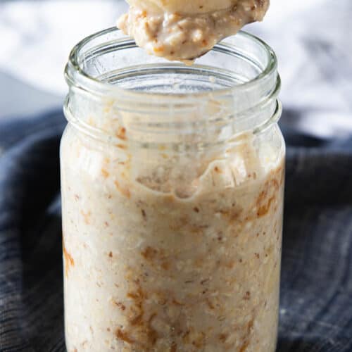 spoon scooping a bite of oatmeal from mashed jar