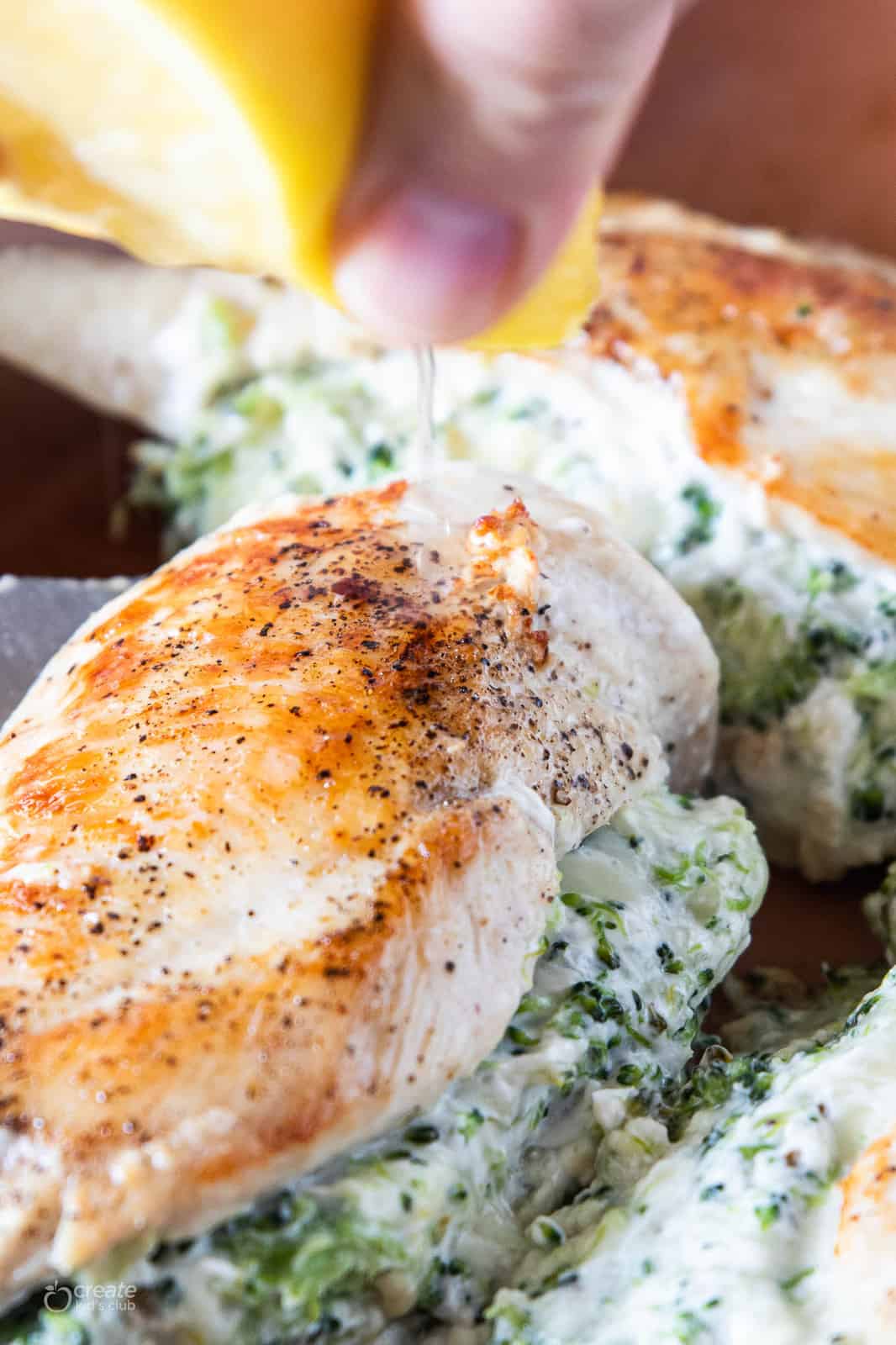 lemon squeezed over stuffed chicken breast