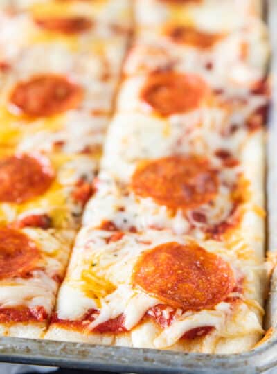 close up of a rectangle pizza on a sheet pan