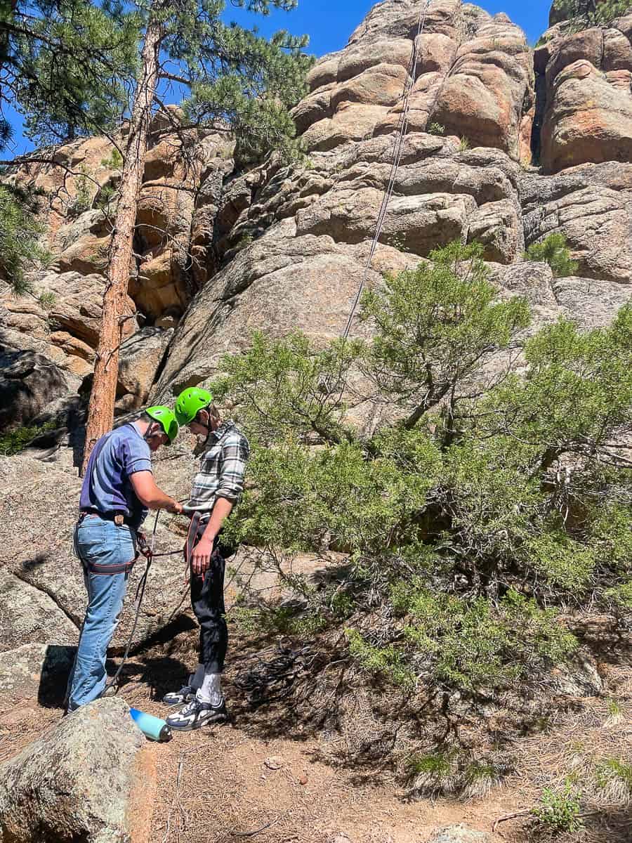 family climbing rocks in colorado