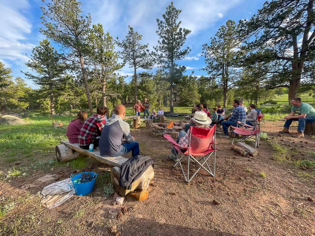 ranch guests gathered around a campfire