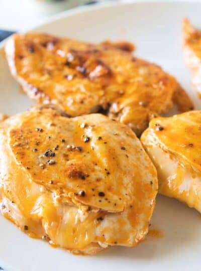 cheesy buffalo chicken breasts on serving plate