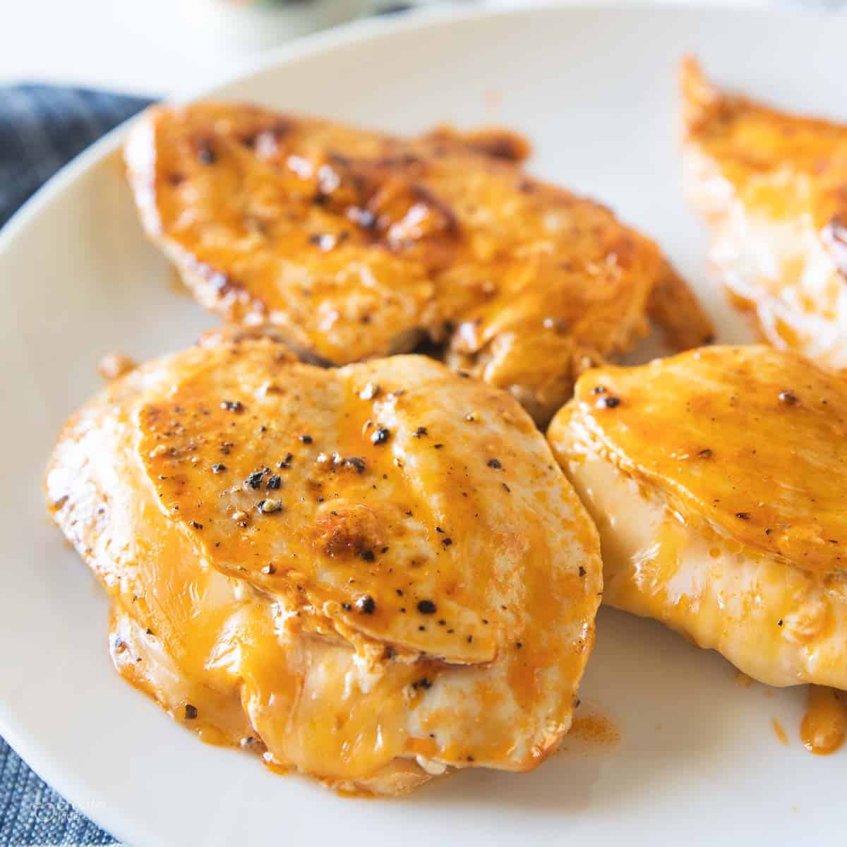 cheesy buffalo chicken breasts on serving plate