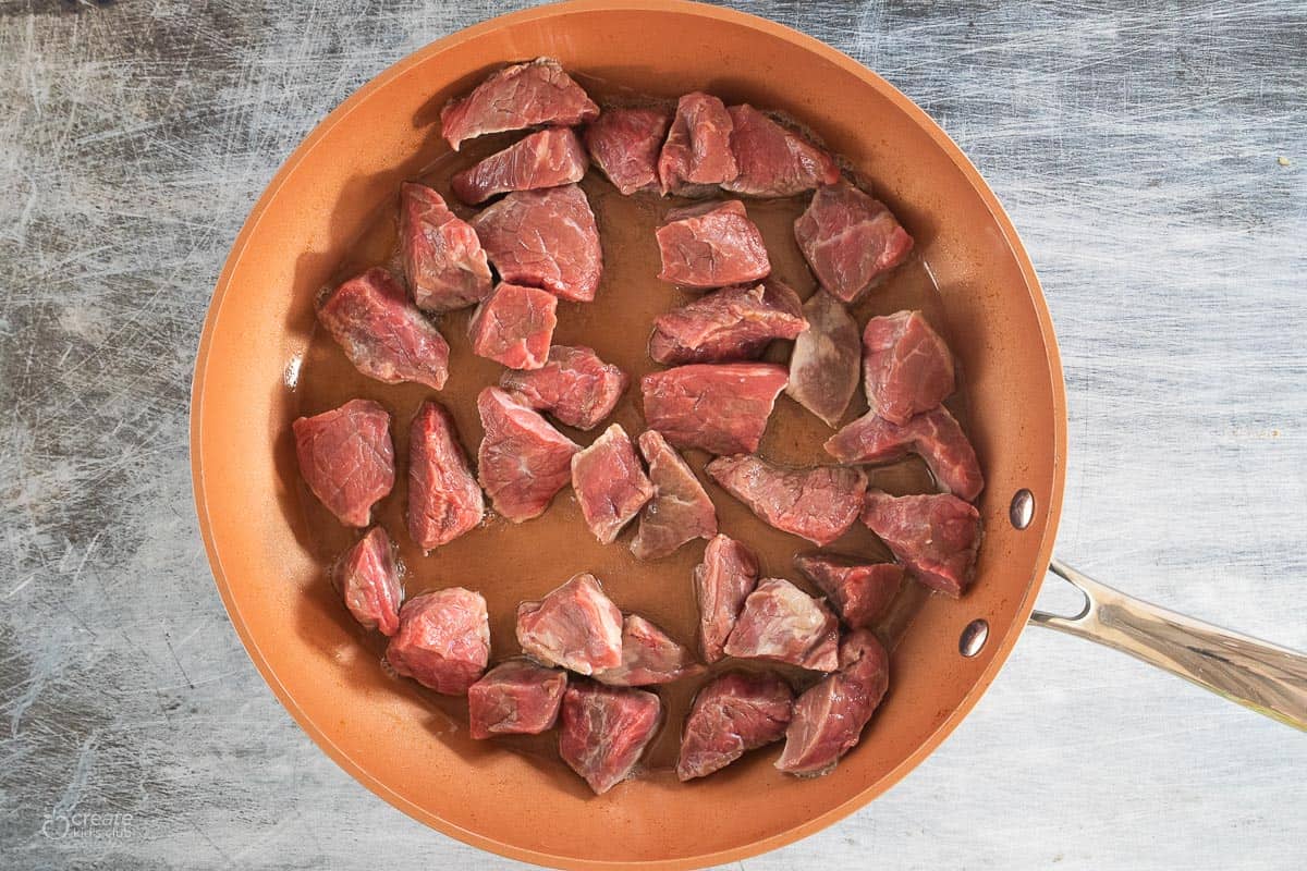 stew meat in pan