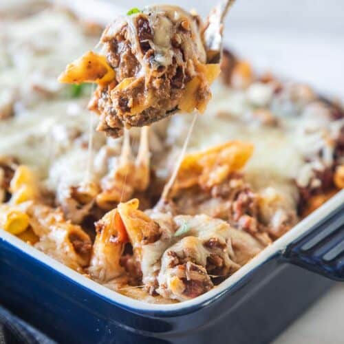 spoon scooping baked ziti with sausage