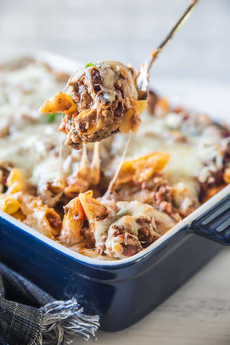 spoon scooping baked ziti with sausage