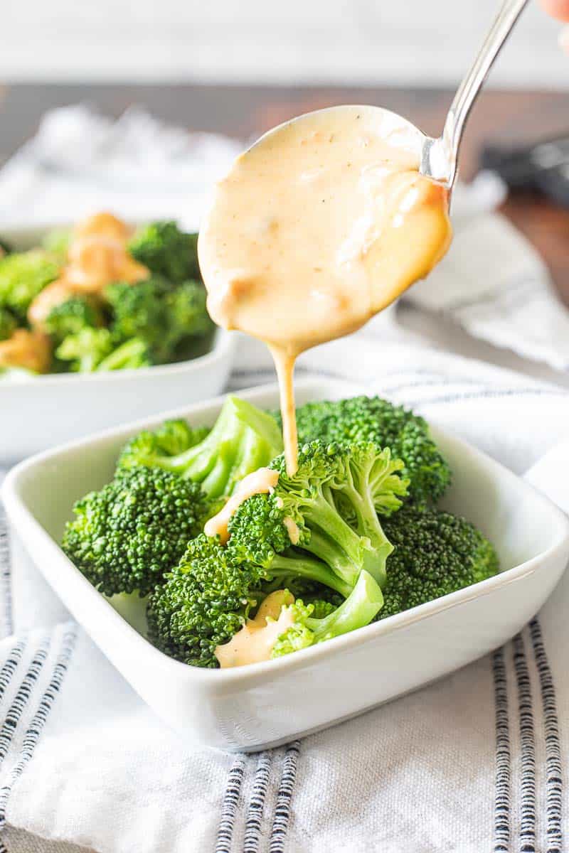 cheese sauce drizzled over broccoli