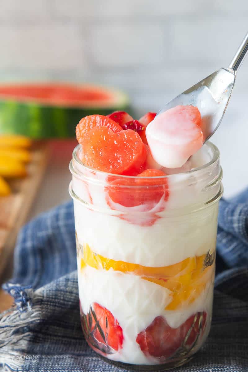 spoon in fruit and yogurt parfait