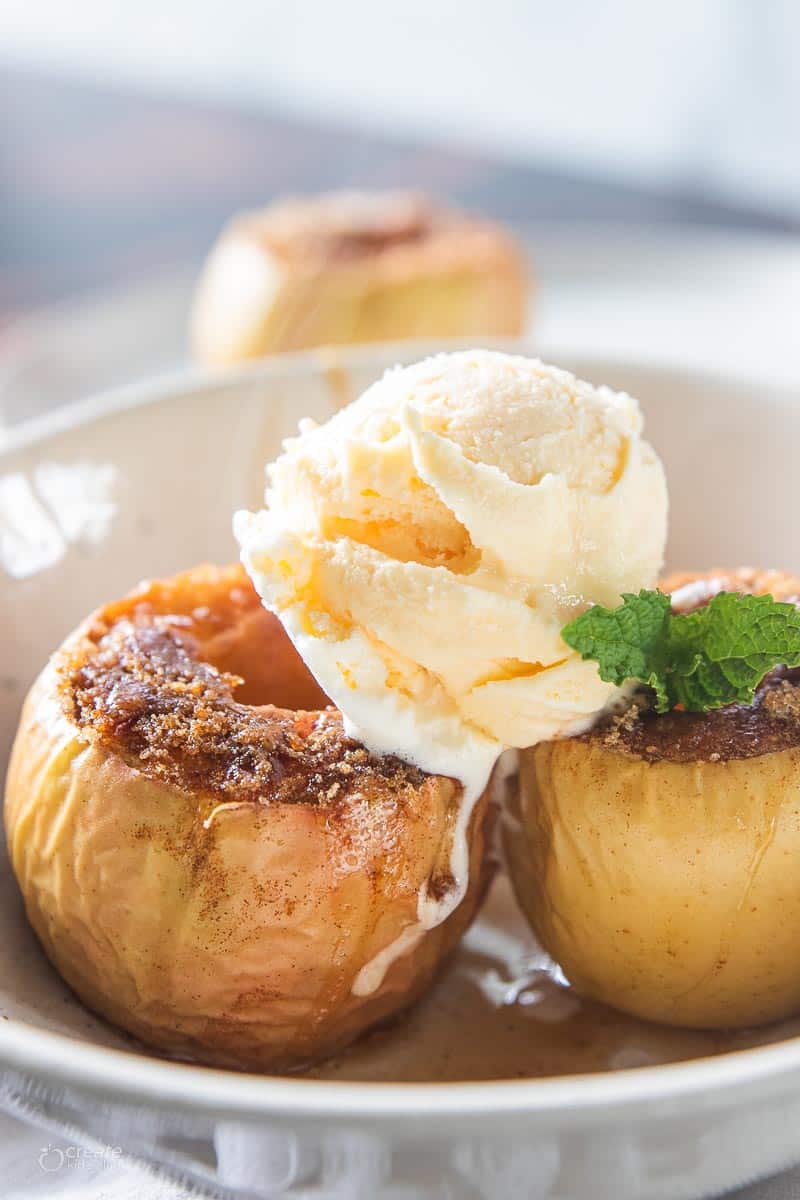 baked apples topped with scoop of vanilla ice cream