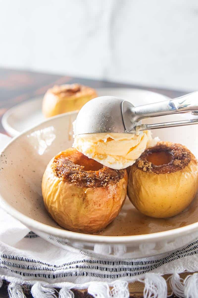 baked apples topped with scoop of vanilla ice cream