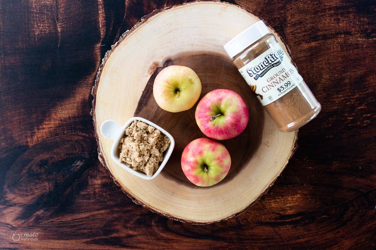 ingredients for air fryer baked apples on a wood slab