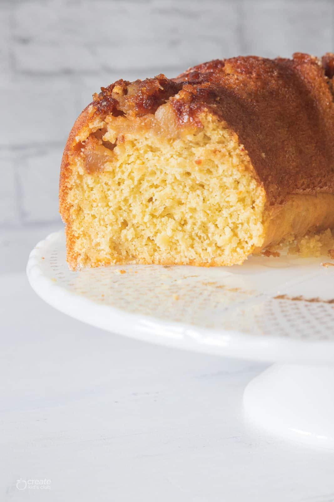 half loaf of gluten free apple cake on cake stand