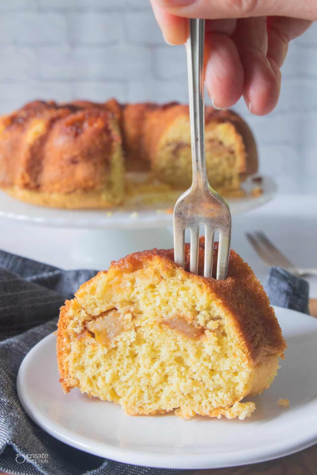 fork in a slice of apple cake