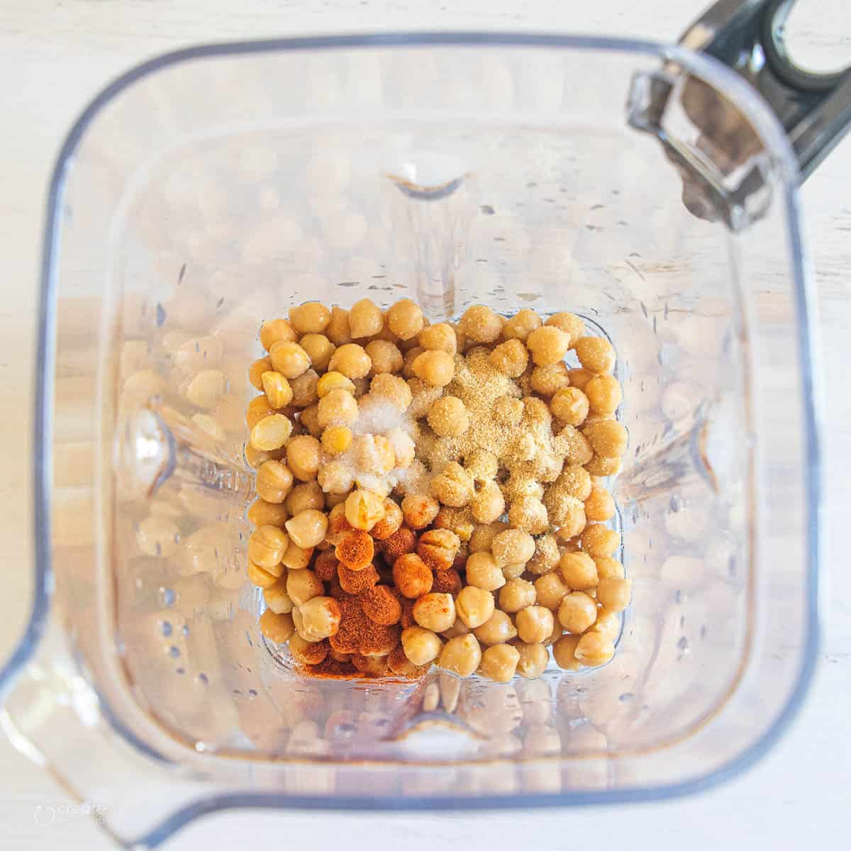 Top down view of chickpeas in a blender.
