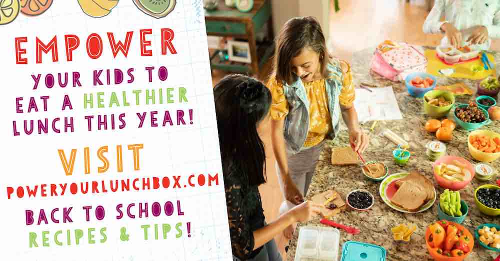 2 girls packing lunches in a kitchen.