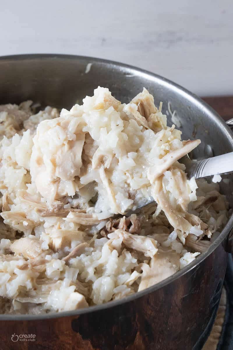 boiled chicken and rice in pan with spoon