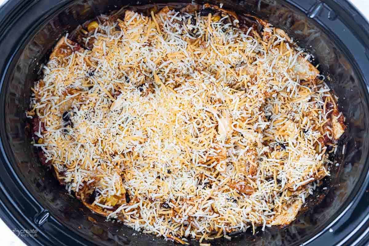 shredded cheese sprinkled on top of crockpot meal