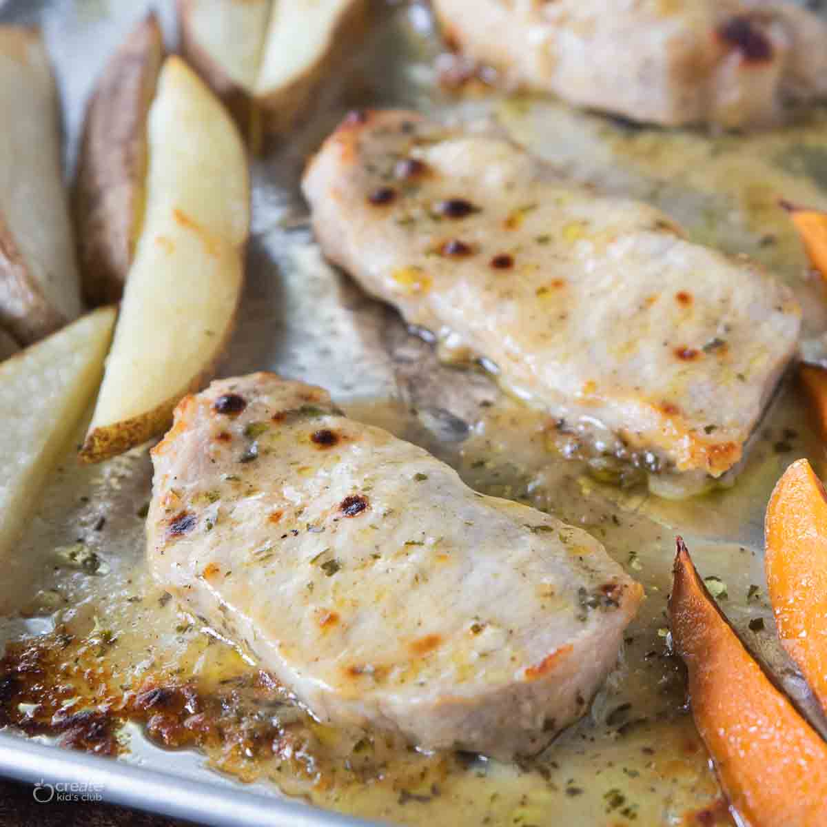 marinated pork chop on sheet pan with potatoes