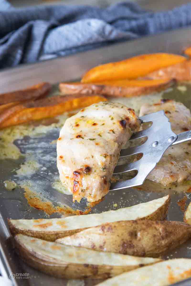 pork chop scooped by spatula from sheet pan