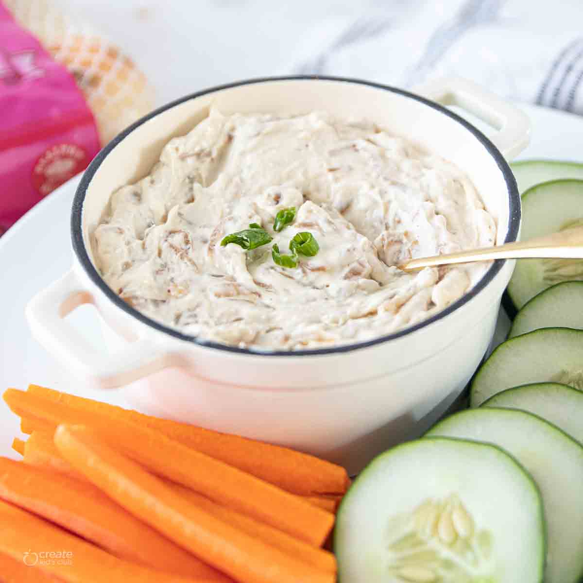caramelized sweet onion dip in bowl with gold spoon