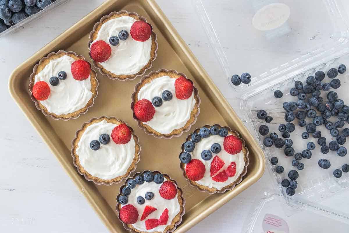 fresh berries added to fruit tarts