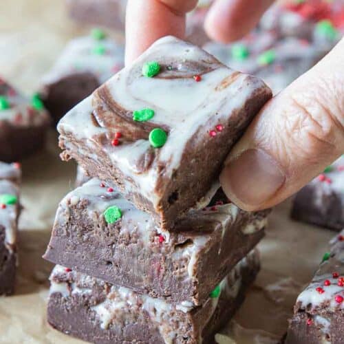 hand picking up a square of Christmas fudge