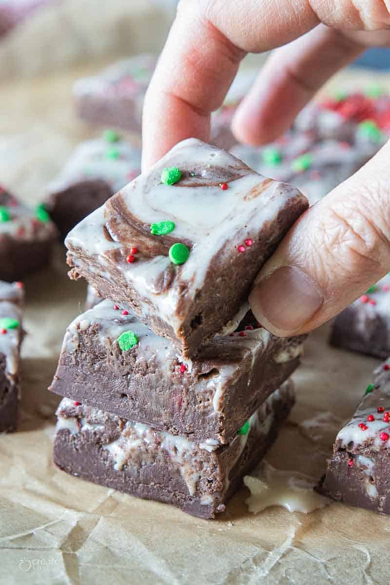 hand picking up a square of Christmas fudge