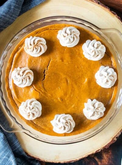 dollops of whipped topping on a pumpkin pie