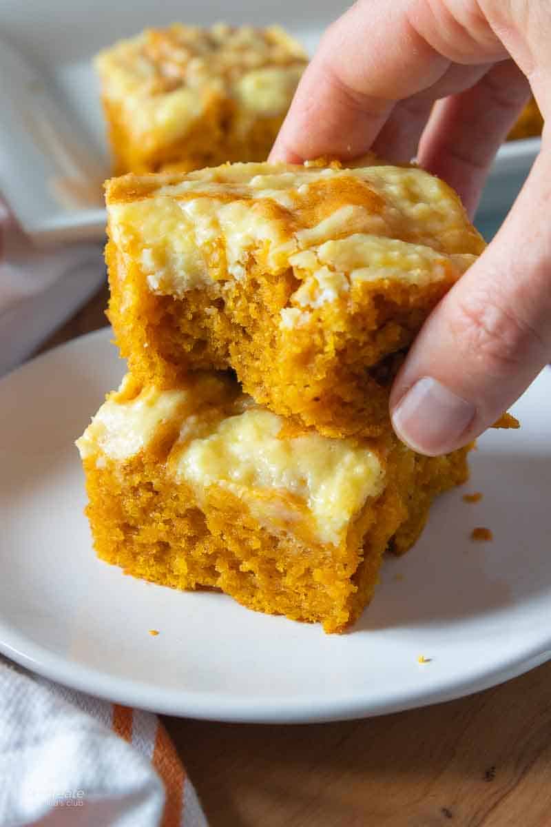 hand holding pumpkin bar with missing bite