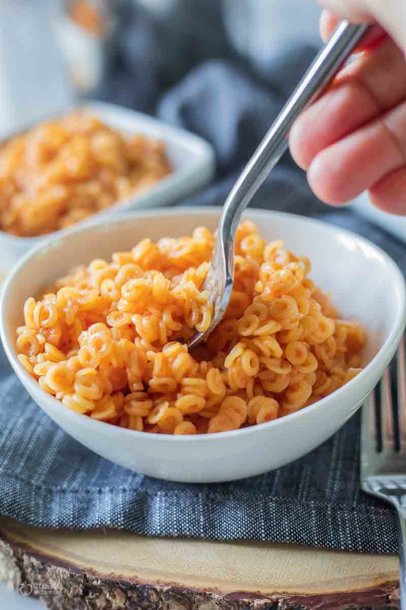 gluten free spaghettios in a bowl with a fork