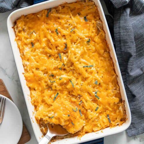 top view of spoon in dish with cheesy potatoes