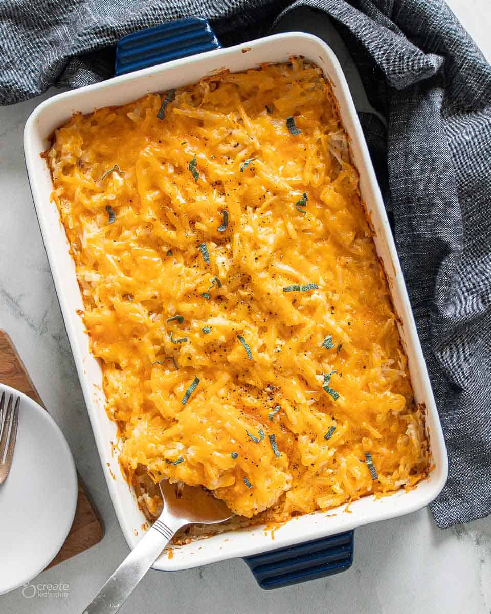 top view of spoon in dish with cheesy potatoes