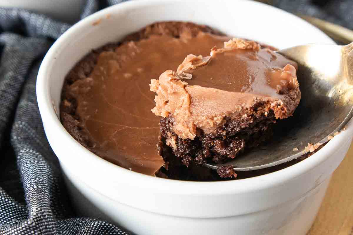 Ramekin with chocolate cake and hardened boiled icing.