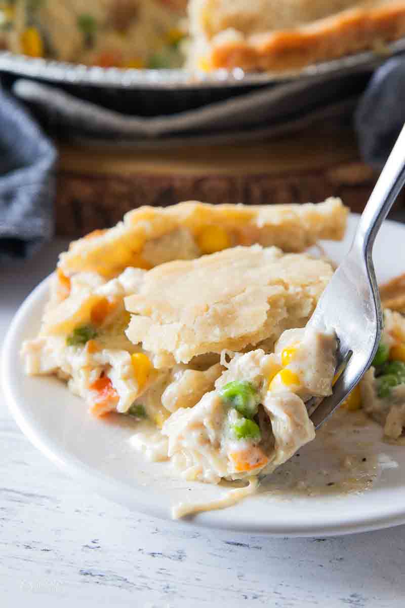 fork scooping a bite of chicken pot pie from a plate
