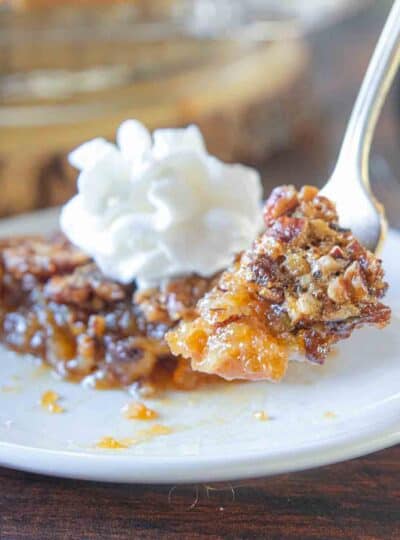 fork scooping a bite of gluten free pecan pie