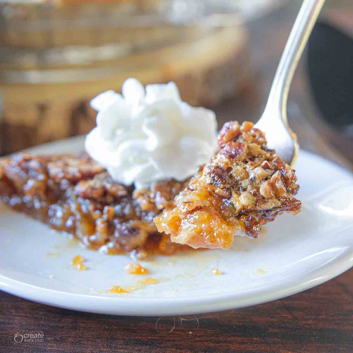 fork scooping a bite of gluten free pecan pie