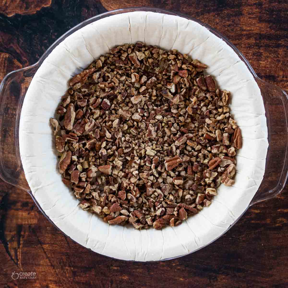 toasted pecans at bottom of gluten free pie shell