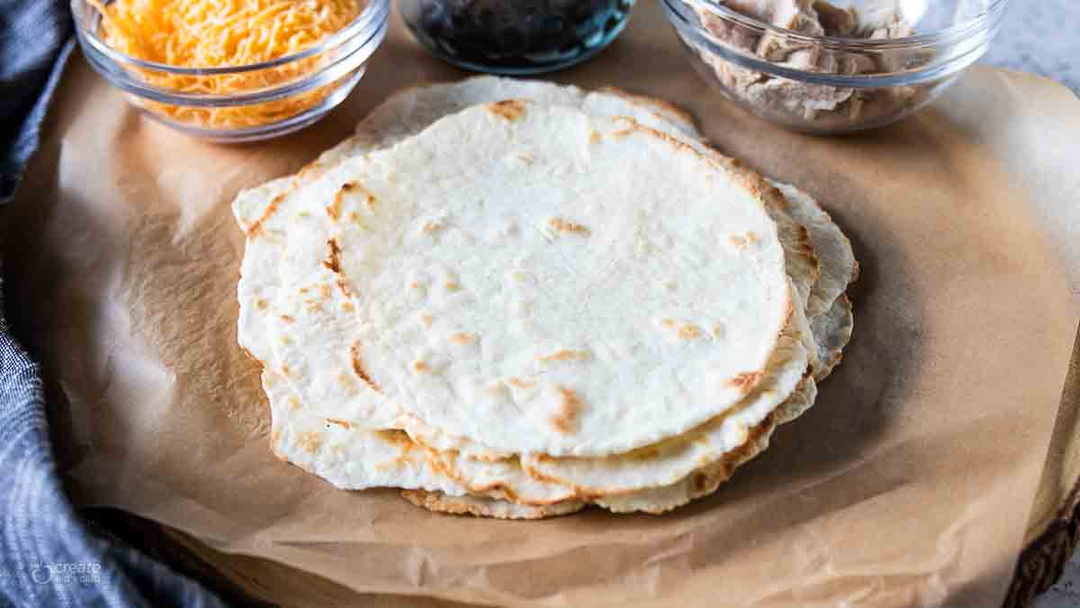 stacked gluten free tortillas on top of parchment paper