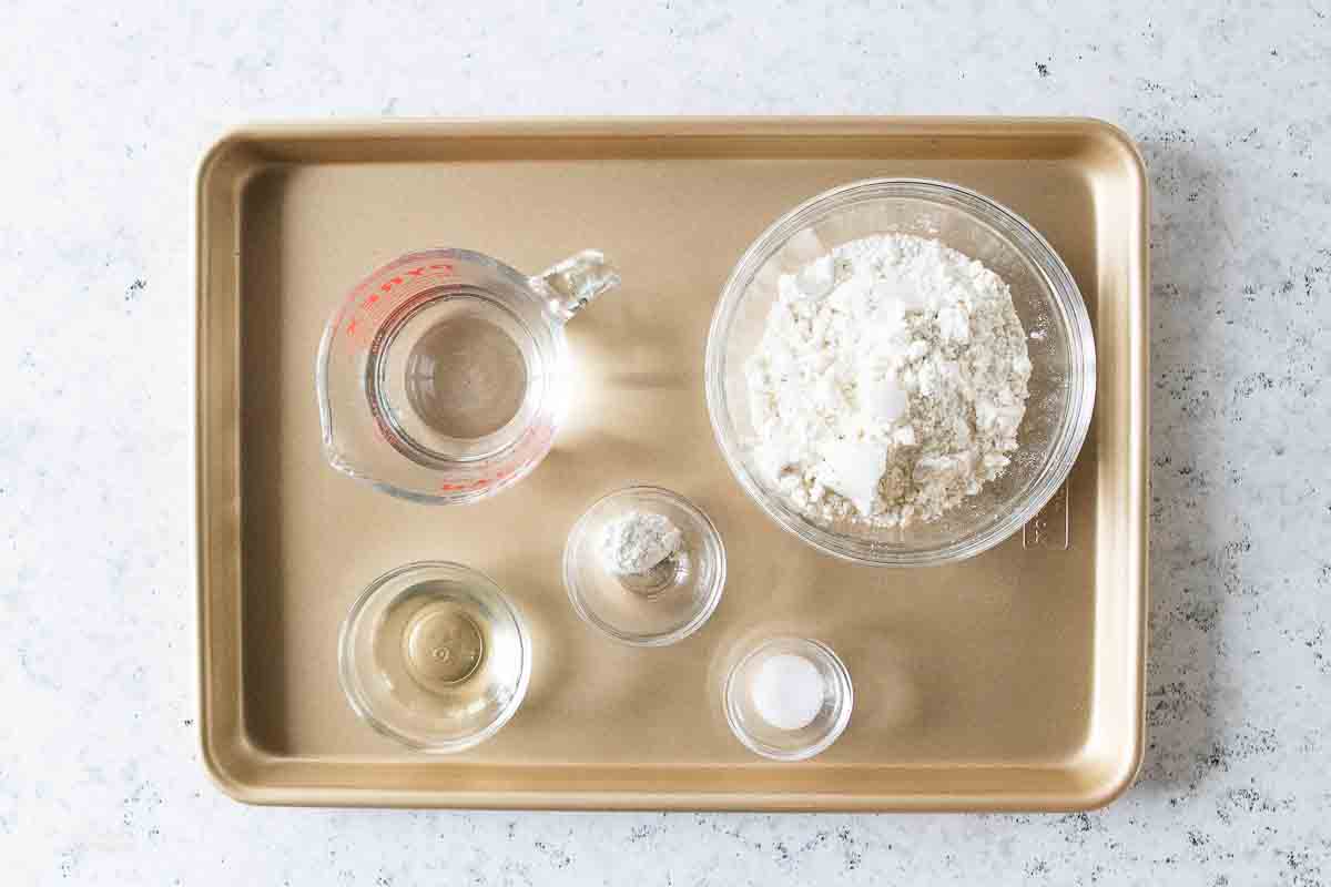 water, salt, oil, gluten free flour on a baking sheet for gluten free tortilla recipe