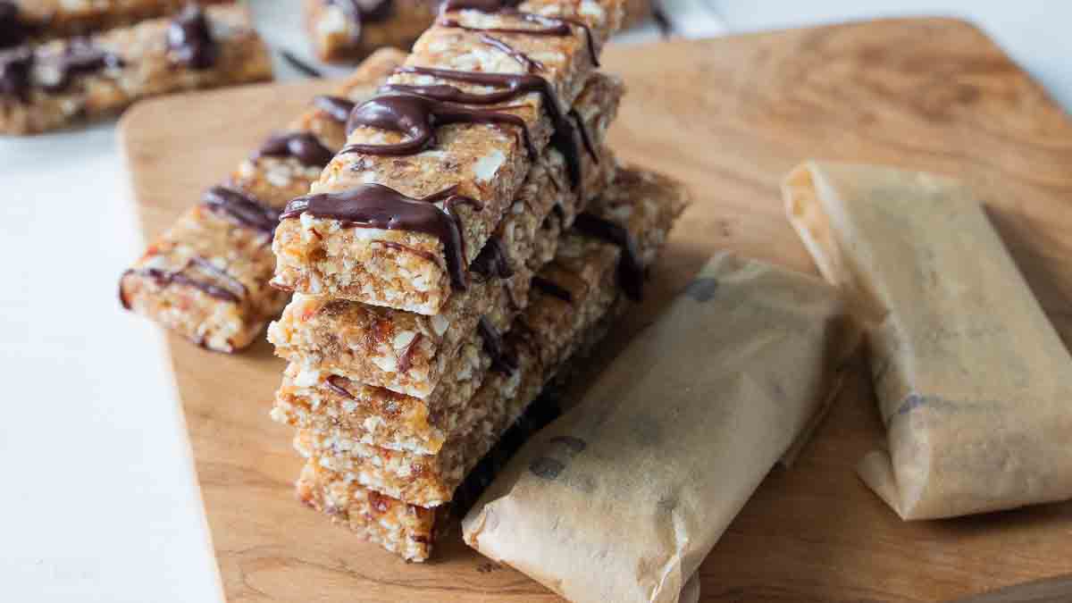 protein bars wrapped in parchment paper next to stacked bars