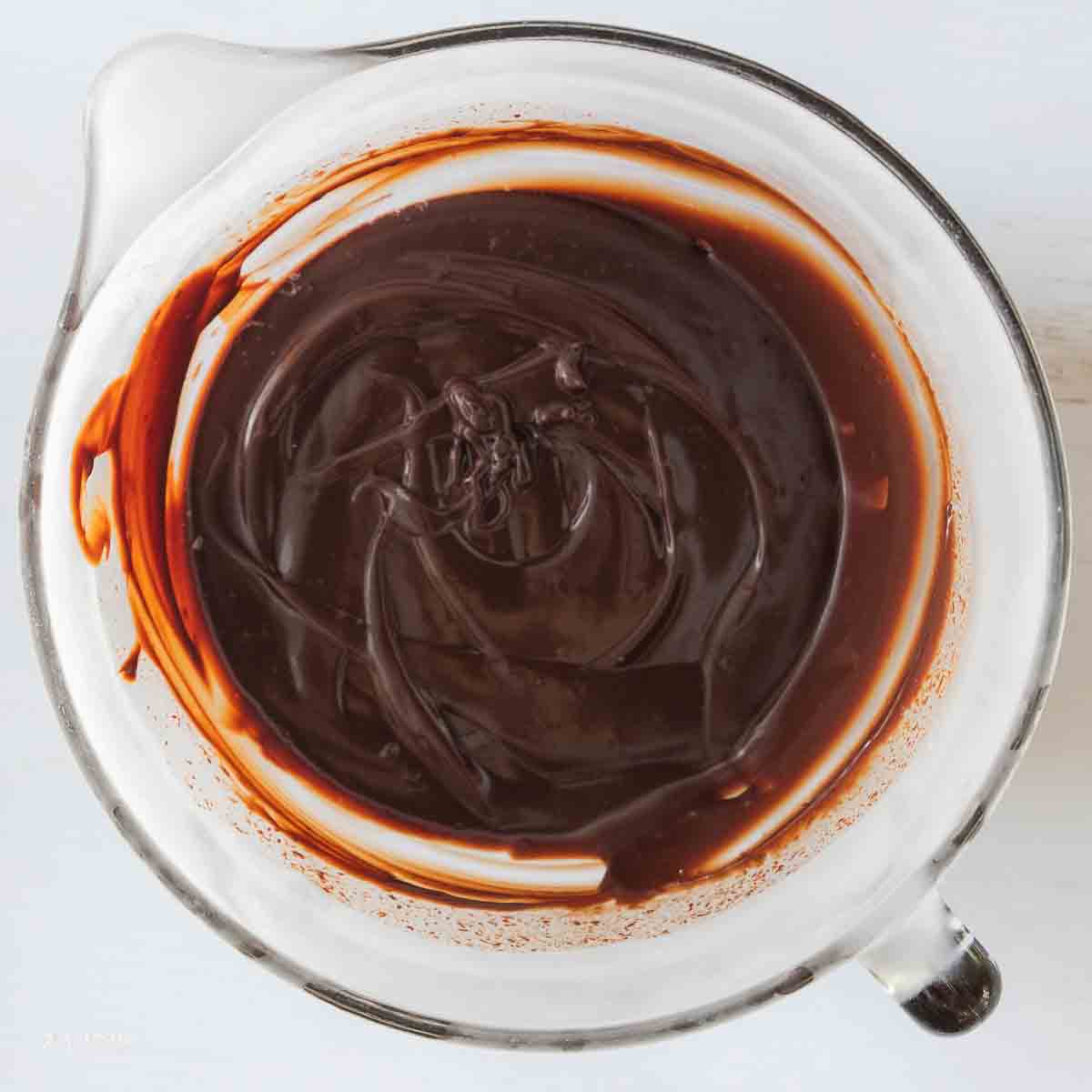 Melted chocolate in a glass bowl.