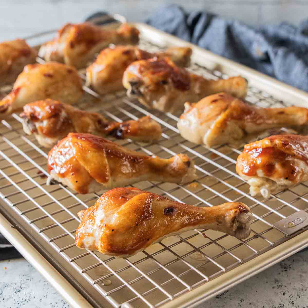 boiled chicken legs on wire rack on top of baking sheet